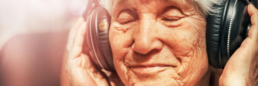 old woman in headphones listening to music